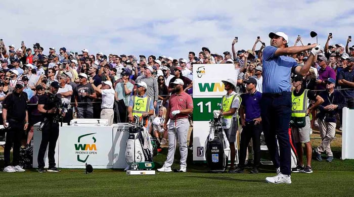 Scottie Scheffler tees off in the final round of the WM Phoenix Open.